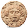 Magna Graecian terracotta antefix. Late 5th century B.C. 8 in. diameter.