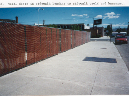 Metal door in
        sidewalk above sidewalk vault