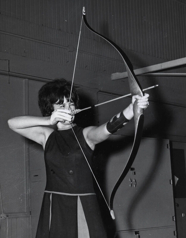 woman aiming a bow and arrow