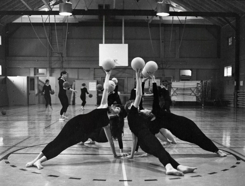 women practicing rhythmic gymanstics (with ball) in Old Memorial Gym