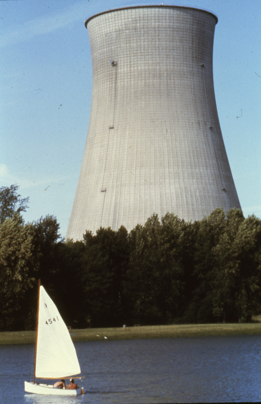 Cooling tower with sail boat in the foreground.