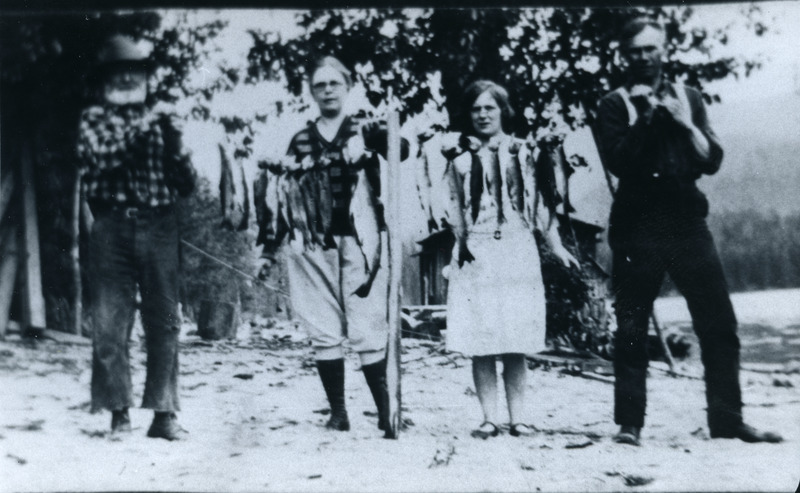 Two couples with a string of fish