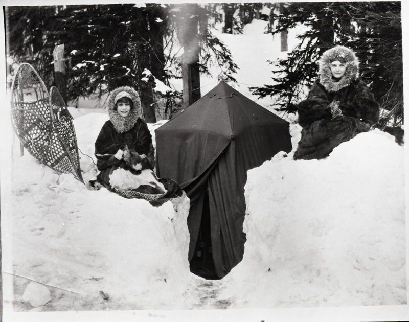 Nell Shipman and Dot Overmyer by a tent in the snow