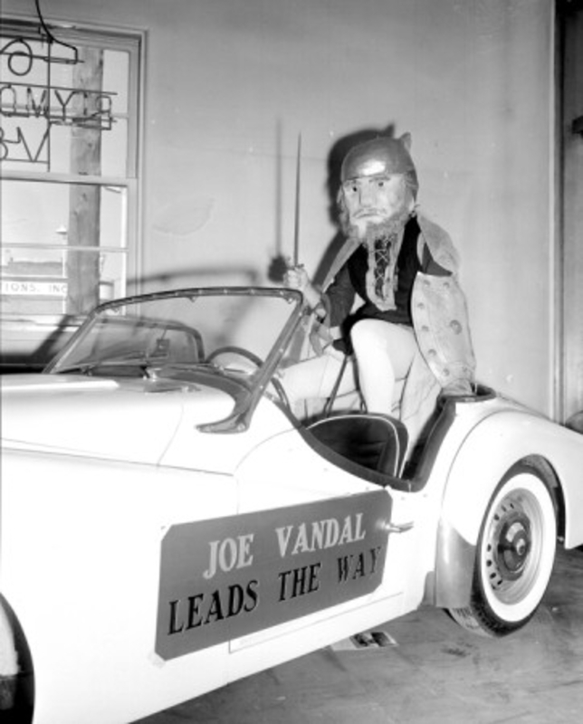 student dressed as Joe Vandal in sports car