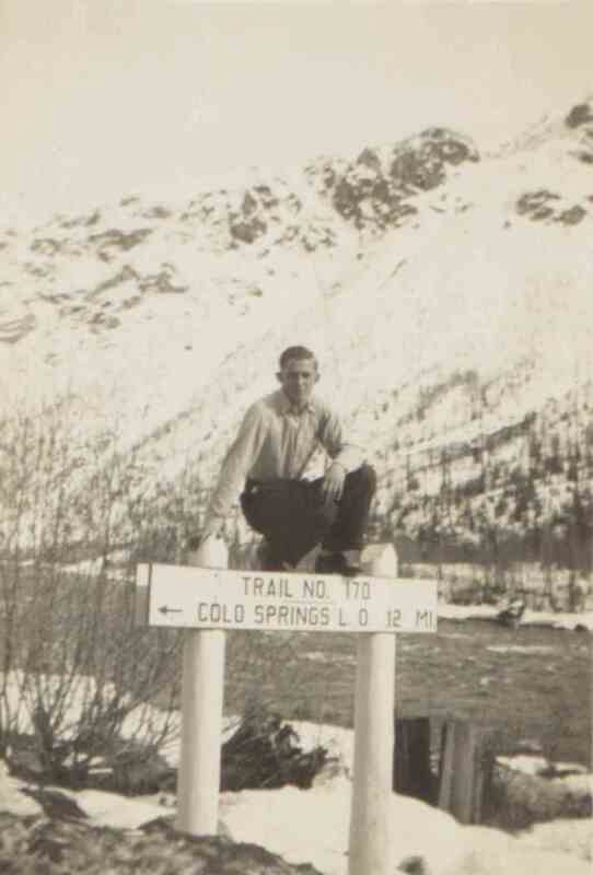 Friend of Arnold Sherwood Bates on trail sign at Camp F-123, near Pierce