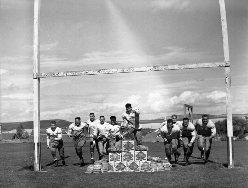 1940 football team rushing the opposing team, a stack of New Sweden Idaho Potatoes