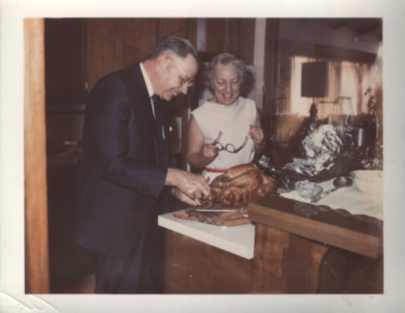 Dee and Burton Ellis preparing a turkey