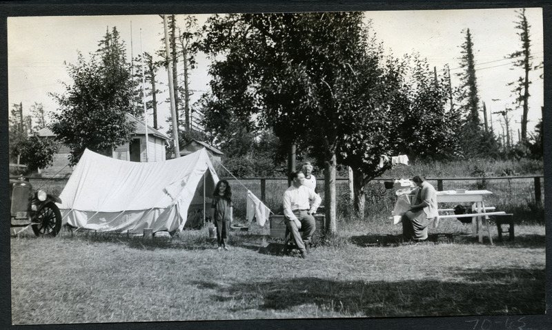 Unidentified (one man, two women and a girl) family camping