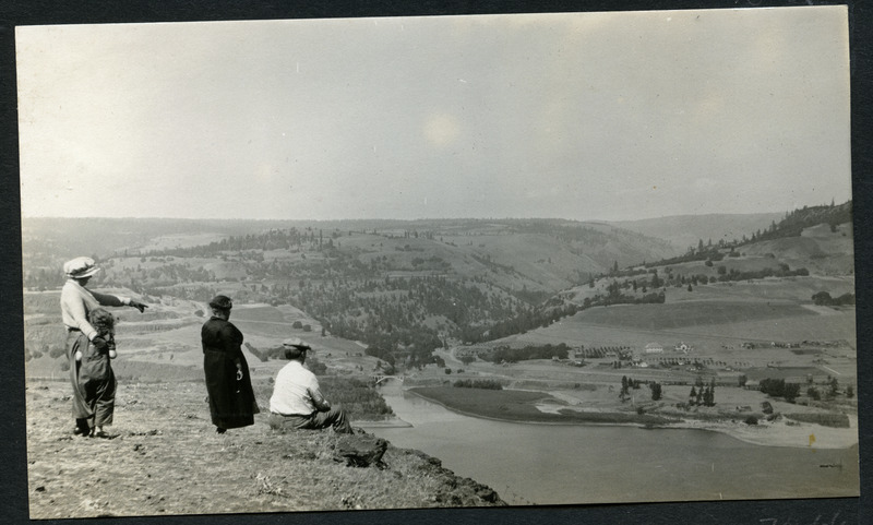 Unidentified women and child looking out at a scenic view