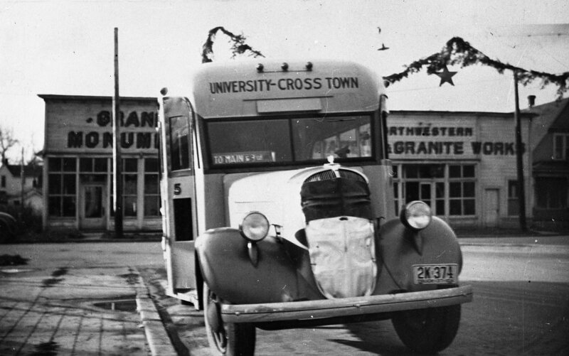 Neely and Sons cross town bus, parked on the South side of 4th Street East of Jackson