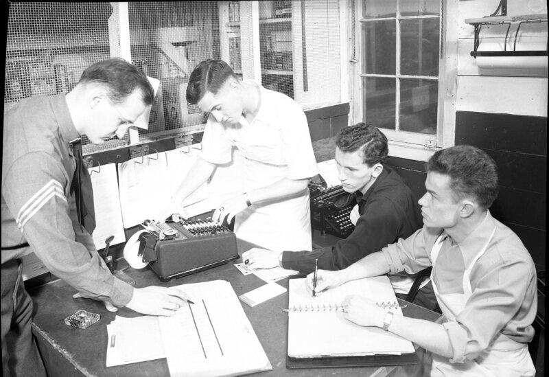 men with typewriter and adding machine at CCC Camp