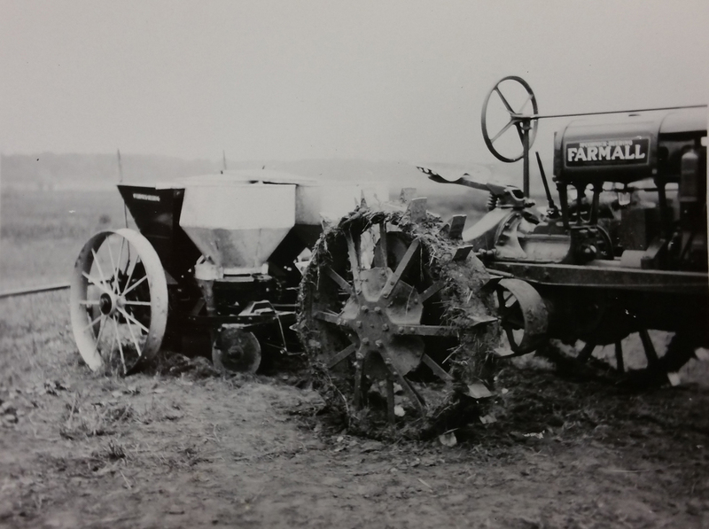 potato planter pulled by Farmall tractor